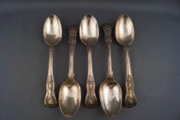 A set of four silver Kings pattern dessert spoons, each engraved with a monogram, London 1864,