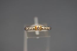 A yellow and white metal single stone ring set with a round brilliant cut diamond measuring