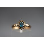 A hallmarked 9ct gold cluster ring set with an oval aquamarine measuring 4.70mm x 4.20mm.