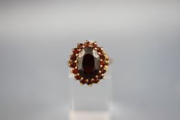 A yellow gold large garnet cluster ring, hallmarked 9ct gold, 1999. 5.9 grams.