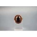 A yellow gold large garnet cluster ring, hallmarked 9ct gold, 1999. 5.9 grams.