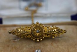 A Victorian 15 carat gold brooch, in case.