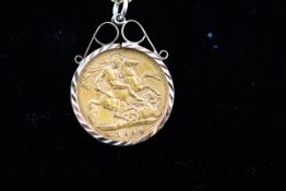 A 1/2 Sovereign pendant in diamond cut scroll mount dated 1894, Victoria.