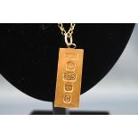 A hallmarked 9ct gold ingot pendant suspended from a belcher link chain, bolt ring clasp, 560mm.