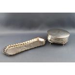 An oval silver trinket box, the engine turned hinged cover engraved with a monogram,