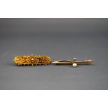 A collection of two 15ct gold brooches : One bar brooch set with a 4.