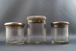 A cut glass oval dressing table jar with embossed silver cover, 9.