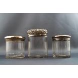 A cut glass oval dressing table jar with embossed silver cover, 9.