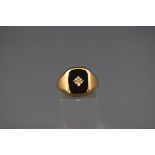 A hallmarked 9ct gold signet ring set with onyx and a central illusion set diamond. Gross weight: 5.