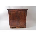 A 19th century mahogany hanging cabinet with cross banded drawer and shaped apron