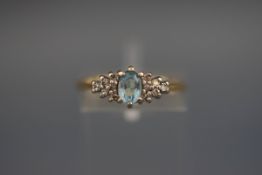 A hallmarked 18 carat gold dress ring set with aquamarine and diamonds. Gross weight; 2.