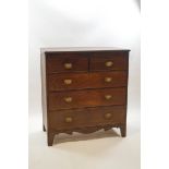 A George III mahogany chest of two short over three long drawers with oval brass handles,