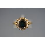A hallmarked 18ct gold cluster ring set with an oval sapphire measuring 9.10mm x 7.00mm.
