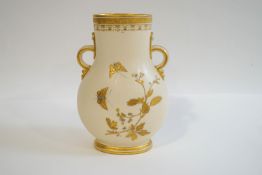 A Minton porcelain two handled vase with prolific gilt decoration of plants to one side,