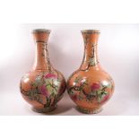 A pair of Chinese porcelain vases painted in enamels with flowering and fruiting peach branches,