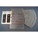 A large selection of multiple pairs of silver earrings together with 6 silver charms