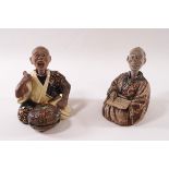 A pair of 19th century Chinese terracotta nodding figures of seated musicians,
