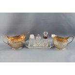 A silver half reeded cream jug and matched two handled sugar bowl, Chester 1921 and Sheffield 1909,