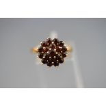 A hallmarked 9ct gold garnet cluster ring. Gross weight: 3.