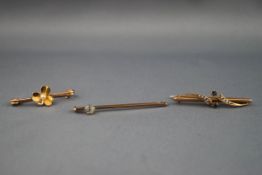 A collection of three bar brooches : One yellow metal bar brooch with central clover set with a