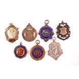 Four silver and enamel fobs and three silver fobs, 2.