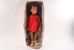 A Trendon Sasha brunette doll, No 104, with red dress,