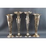 A pair of silver spill vases embossed with spiralling "C" scrolls and flowers,