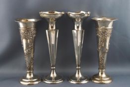 A pair of silver spill vases embossed with spiralling "C" scrolls and flowers,