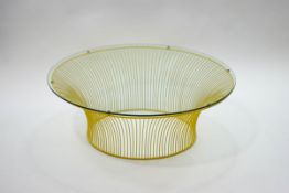 A modern yellow painted metal coffee table, of slatted circular form with glass top,