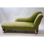 A Victorian chaise longue with turned tapering walnut legs,