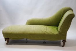 A Victorian chaise longue with turned tapering walnut legs,