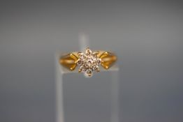 An 18 carat and diamond flowerhead cluster ring. Hallmarked 18ct, Birmingham, 1970. 3.