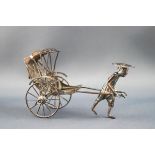 A Chinese white metal model of a man pulling a rickshaw, 5cm high,