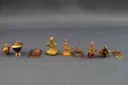 A selection of yellow gold charms consisting of the following: Bristol shield,