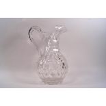 A 19th century cut glass jug, the faceted body bearing various shapes,