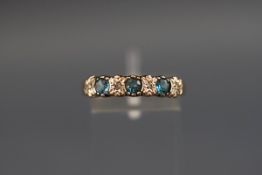 A seven stone ring set with blue topaz and diamonds, hallmarked 9ct, London, stamped 'DIA', 2.
