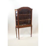 A Dutch marquetry display cabinet on later square tapering legs,
