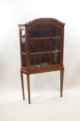 A Dutch marquetry display cabinet on later square tapering legs,