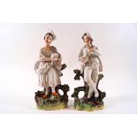 A pair of 19th century Staffordshire pottery figures of a lady with a lamb and her male companion