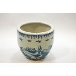 A large Chinese fish bowl painted in underglaze blue with figures in a river landscape,