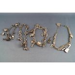 A selection of four silver bracelets each with assorted charms,