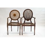 An Edwardian mahogany elbow chair with caned seat and back, inset with inlaid plaque,