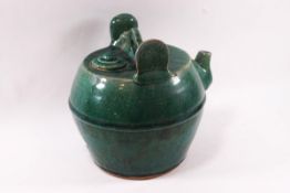 A Chinese stoneware teapot and cover of globular form with green glaze,