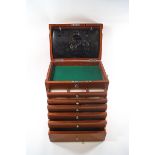 A mahogany specimen cabinet with folding chrome handle,