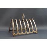 A silver toast rack, with inverted shield shaped handle, 13.5cm wide, Sheffield 1932, 3.