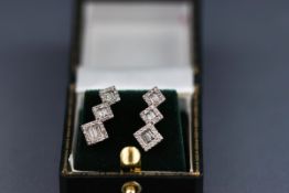 A pair of diamond drop earrings,