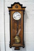 A 20th century Vienna regulator clock with ebonised and burr wood case, pendulum and single weight,