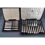 A set of six cased butter knives, each with silver handles,
