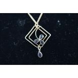 A stamped 9C square pendant of abstract design set with amethyst,