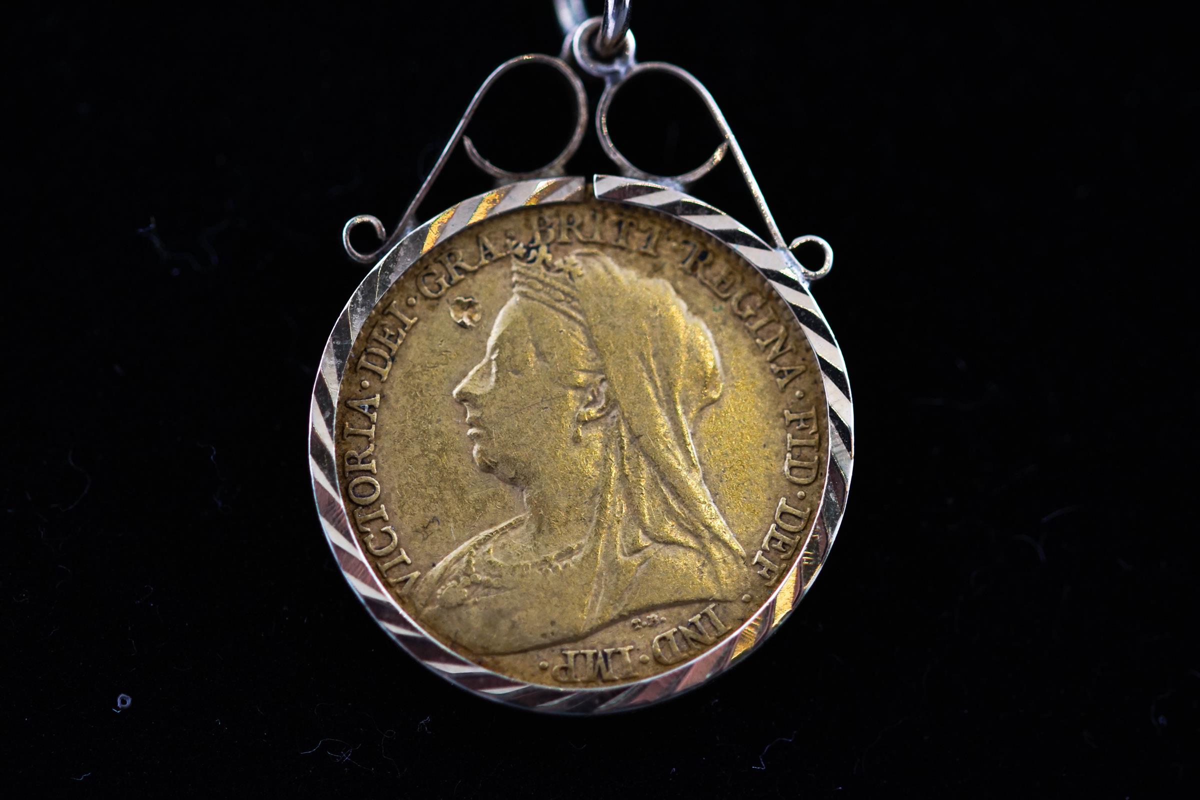 A 1/2 Sovereign pendant in diamond cut scroll mount dated 1894, Victoria. - Image 2 of 2